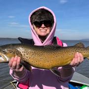 Katie Russell with a solid male brown trout she caught at Lake Sorell