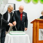 MLC Craig Farrell and Corumbene President and Chair of the Board of Management, Ross Carlyle.cutting the 60th Birthday cake watched on by Corumbene CEO Alison Standen. 