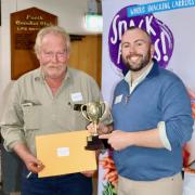 Andrew Craigie accepts the Excellence in Agriculture award  from field officer Dylan Bellchambers.