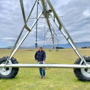 Alex Downie with a new pivot irrigator at Fairfield, Epping.