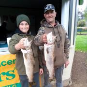 New Norfolk Licensed Anglers Association members Adrian Slater and his son Jayden with their winning catches from last weekend’s Derwent River competition.