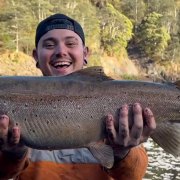 Kade Wall with the magnificent female brown trout he caught and released in the Pieman River.
