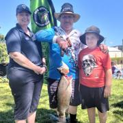 Inland Fisheries Service executive officer Vanessa Britten and NNLAA president Laurie Harrison with nine-year-old Caleb Quarrell and his 5.4kg rainbow trout caught during Sunday's Gone Fishing Day celebrations.
