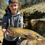 Zeke Rice, 13, with a big brown trout caught recently in the Clyde River. It was only the second trout he has caught.