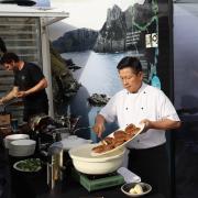 Seafood buyers watching abalone being prepared